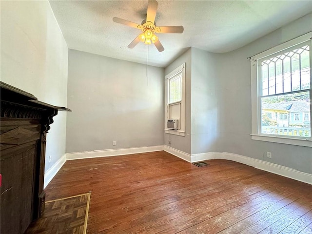 unfurnished living room featuring a textured ceiling, ceiling fan, and hardwood / wood-style floors