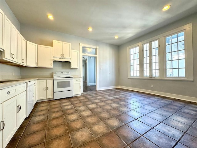 593739 Freret St, New Orleans, LA 70115 - kitchen featuring white appliances, under cabinet range hood, white cabinetry, light countertops, and recessed lighting