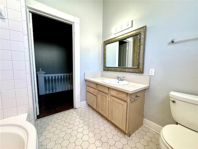 bathroom with vanity, toilet, and tile patterned flooring