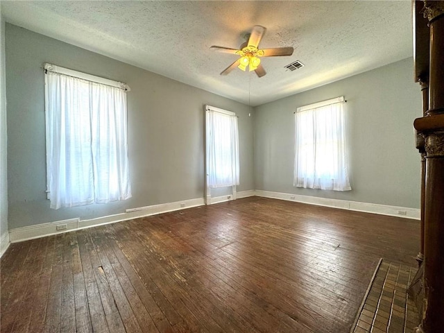 unfurnished living room with dark hardwood / wood-style flooring, a textured ceiling, and ceiling fan