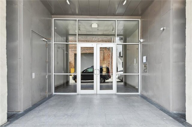 view of exterior entry featuring french doors