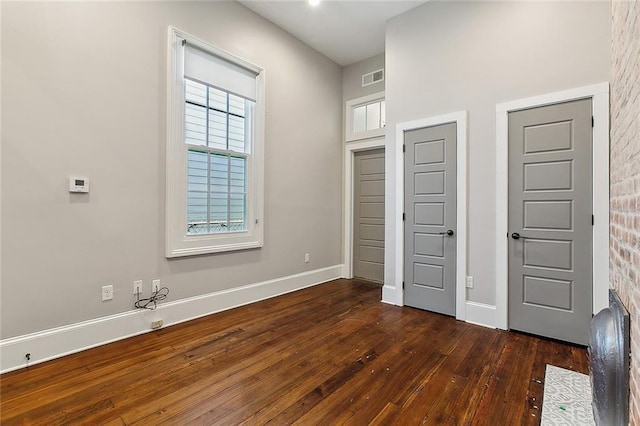 unfurnished bedroom featuring dark wood-type flooring