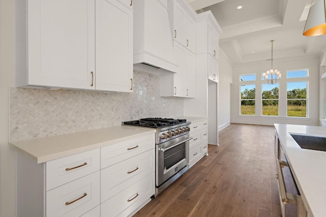 kitchen featuring range with two ovens, white cabinetry, pendant lighting, custom exhaust hood, and dark hardwood / wood-style floors