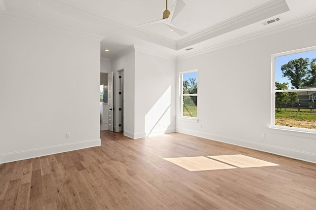 spare room with ornamental molding, light hardwood / wood-style floors, and a healthy amount of sunlight