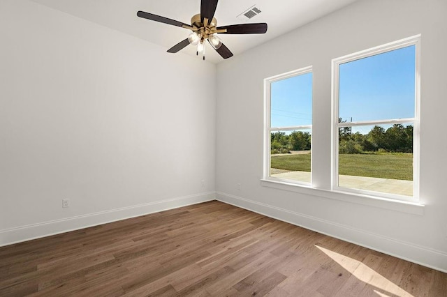 spare room with hardwood / wood-style flooring and ceiling fan