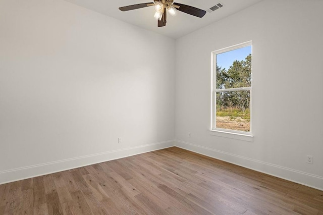 unfurnished room with ceiling fan, light wood-type flooring, and plenty of natural light