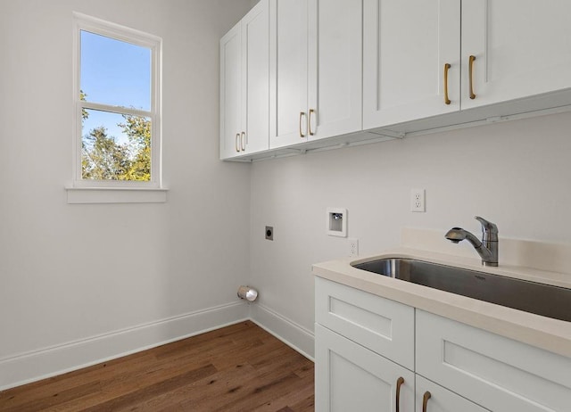 washroom with cabinets, hookup for a washing machine, dark wood-type flooring, hookup for an electric dryer, and sink