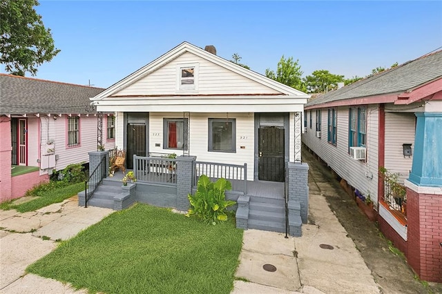 bungalow-style home with a porch and cooling unit