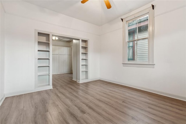 unfurnished bedroom with ceiling fan, hardwood / wood-style flooring, and a closet