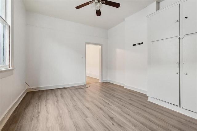 spare room with light hardwood / wood-style flooring and ceiling fan