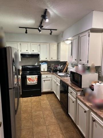 kitchen featuring white cabinetry, black appliances, ventilation hood, rail lighting, and light tile patterned floors