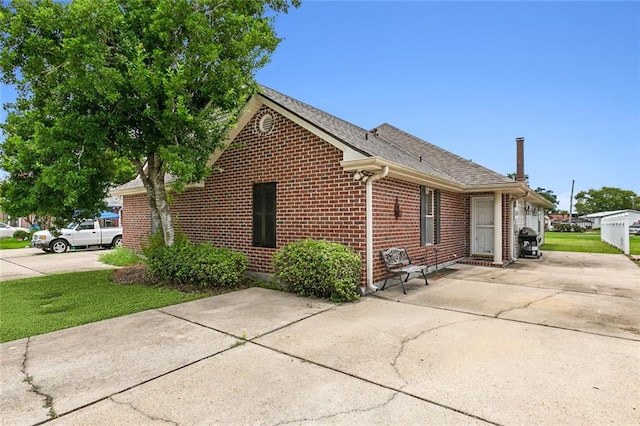 view of property exterior featuring a lawn