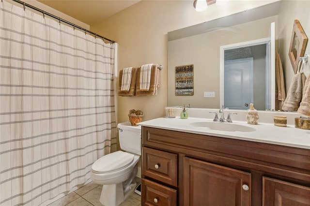 bathroom with vanity, tile patterned flooring, and toilet