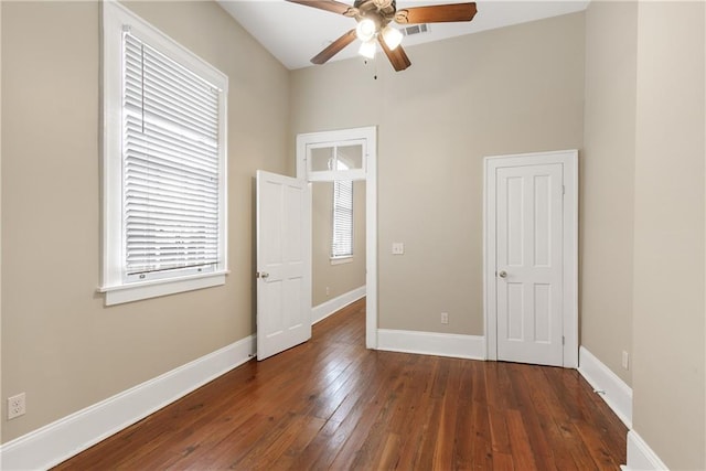 unfurnished bedroom with dark hardwood / wood-style floors and ceiling fan