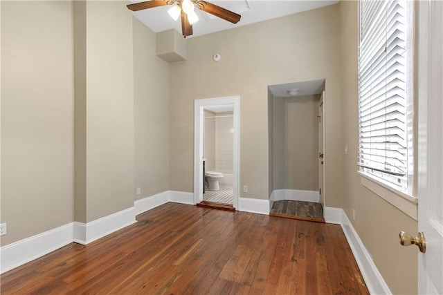 unfurnished room featuring ceiling fan and dark hardwood / wood-style flooring