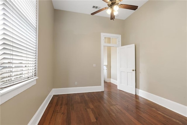 empty room with dark wood-type flooring and ceiling fan