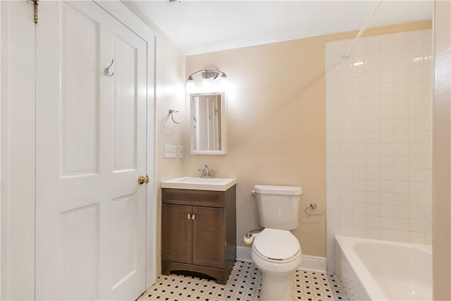 full bathroom with vanity, tiled shower / bath, and toilet