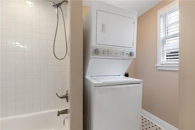 washroom featuring stacked washer / drying machine