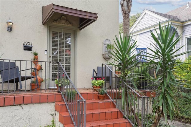 2900-04 Esplanade Ave, New Orleans, LA 70119 - doorway to property featuring stucco siding