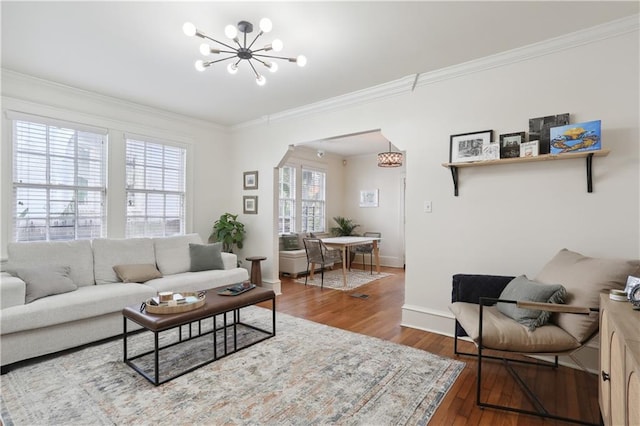 living room featuring ornamental molding, wood-type flooring, and plenty of natural light