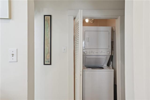 washroom with stacked washing maching and dryer