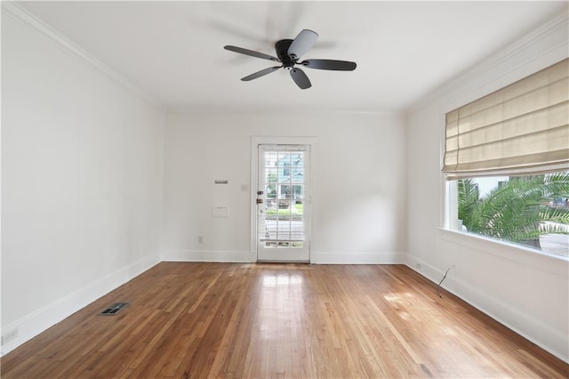 unfurnished room featuring hardwood / wood-style flooring, crown molding, and ceiling fan