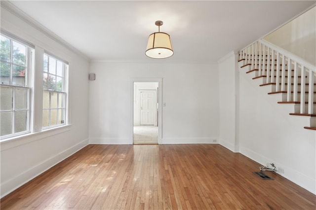 2900-04 Esplanade Ave, New Orleans, LA 70119 - unfurnished room with stairs, light wood-type flooring, and ornamental molding