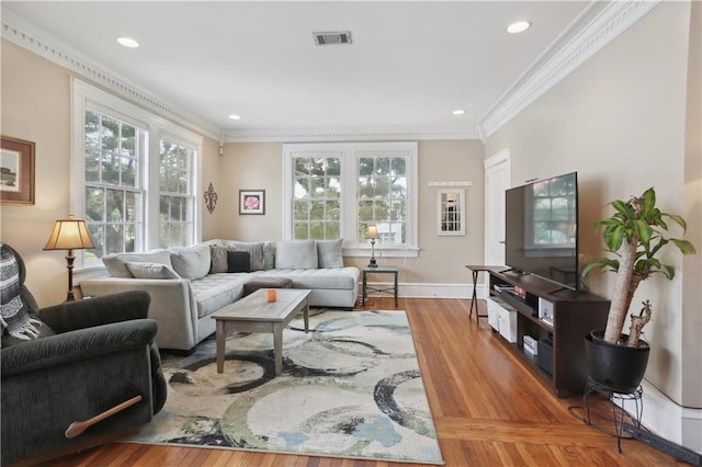 living room with ornamental molding and hardwood / wood-style flooring