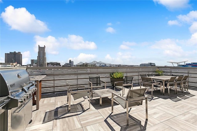 view of patio / terrace featuring exterior kitchen and a grill