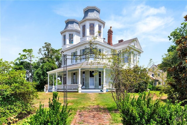 view of front of property with a porch and a front yard