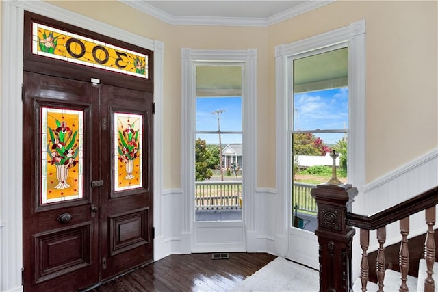 foyer entrance featuring crown molding and dark hardwood / wood-style floors