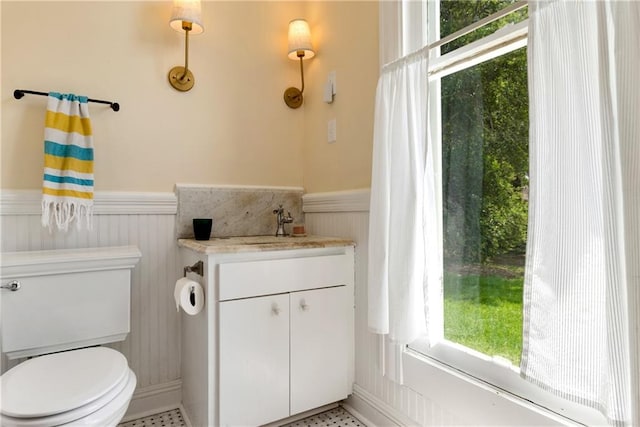 bathroom with tile patterned floors, vanity, and toilet