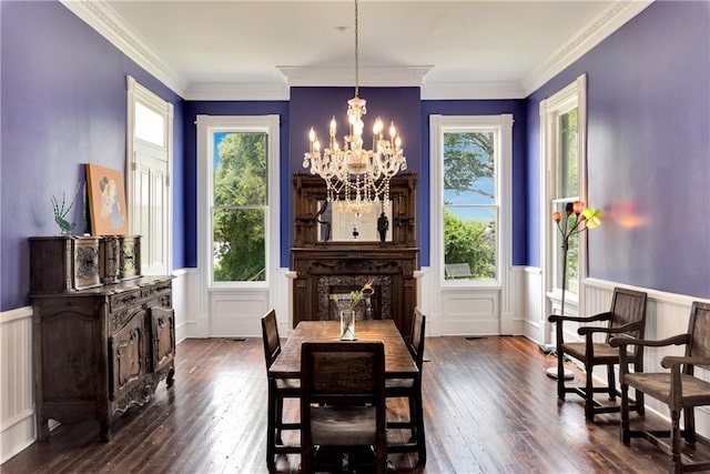 dining space featuring a wealth of natural light, a notable chandelier, and dark hardwood / wood-style floors