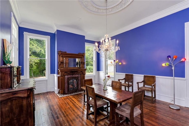 dining space featuring plenty of natural light, an inviting chandelier, dark hardwood / wood-style floors, and a premium fireplace