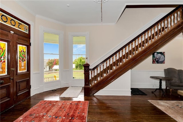 entryway with hardwood / wood-style floors, ornamental molding, stairway, and a decorative wall