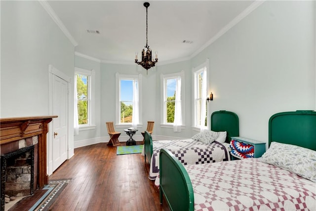 bedroom featuring dark wood-type flooring, ornamental molding, and an inviting chandelier