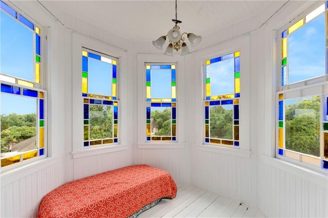 sunroom with a notable chandelier and a healthy amount of sunlight