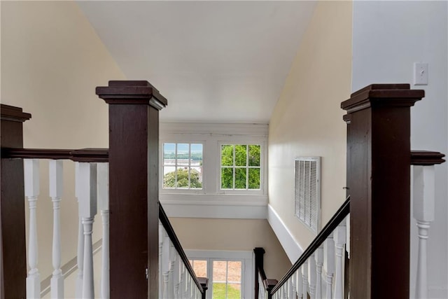 staircase with plenty of natural light and visible vents