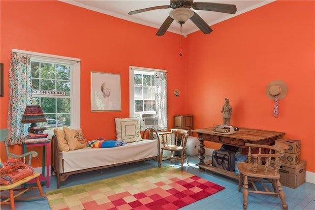 bedroom featuring light hardwood / wood-style floors, crown molding, and ceiling fan