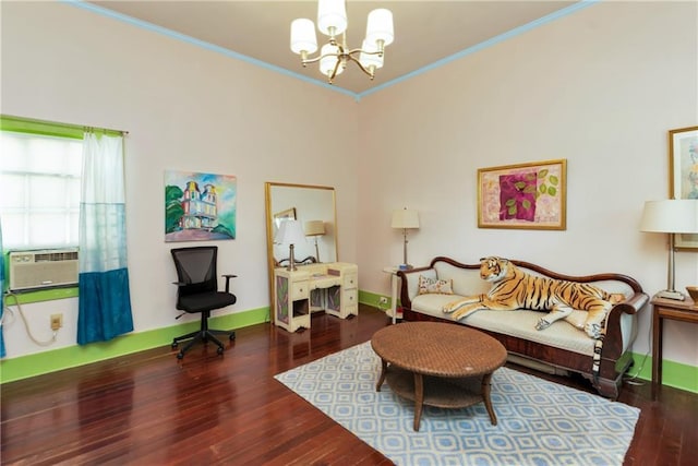 sitting room featuring wood finished floors, cooling unit, ornamental molding, and an inviting chandelier
