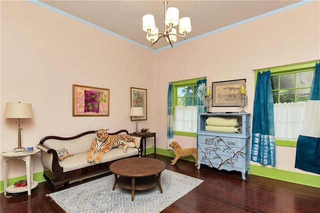 living room with ornamental molding, an inviting chandelier, and wood-type flooring