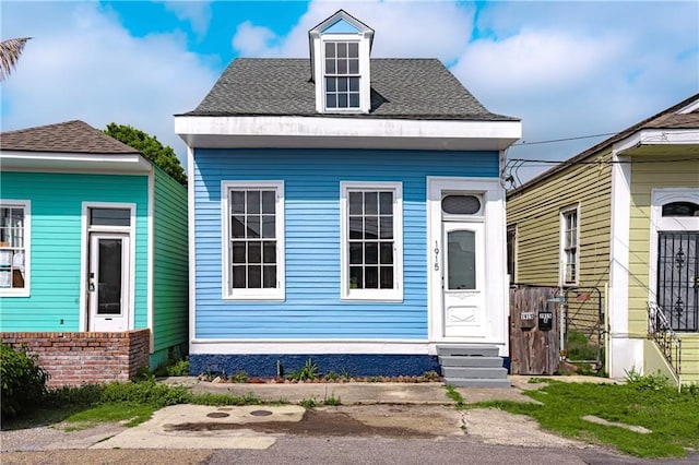 view of front of property featuring a shingled roof and entry steps