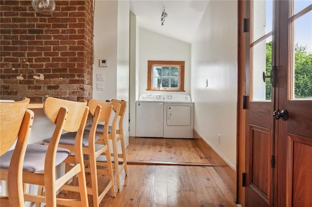 1915 Governor Nicholls St, New Orleans, LA 70116 - foyer featuring lofted ceiling, light wood-style flooring, washer and dryer, and baseboards