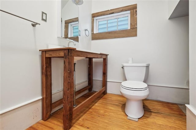 bathroom featuring wood finished floors, vanity, and toilet