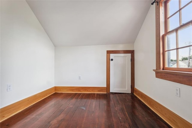 bonus room featuring lofted ceiling, dark wood-type flooring, and baseboards