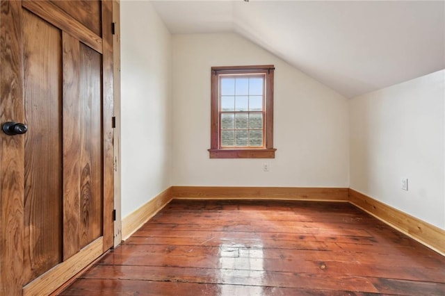 bonus room featuring dark wood-style floors, lofted ceiling, and baseboards