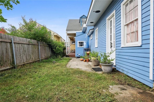 view of yard with fence and a patio