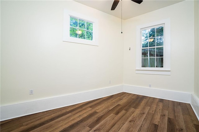 unfurnished room with a ceiling fan, dark wood-style floors, and baseboards