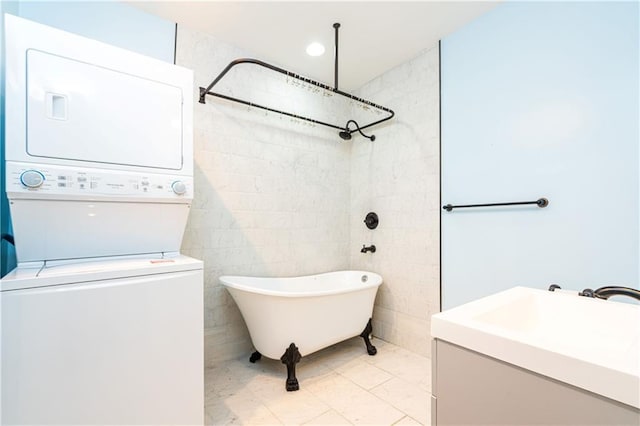 1915 Governor Nicholls St, New Orleans, LA 70116 - bathroom featuring estacked washer and dryer, a freestanding bath, marble look tiles, vanity, and a shower