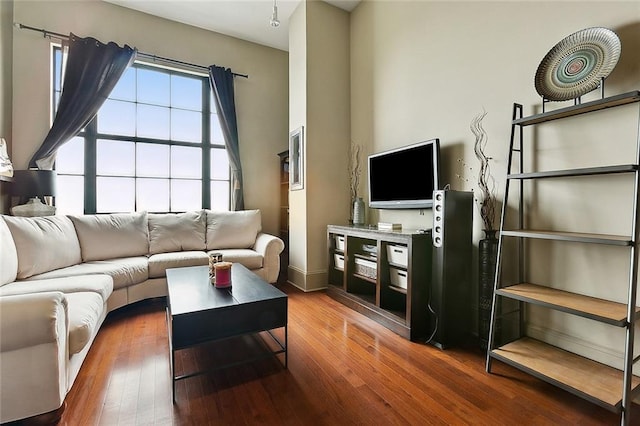 living room with hardwood / wood-style floors and baseboards
